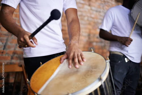 Hands, drum or carnival with a person playing an instrument in a festival in Rio de Janeiro, Brazil. Closeup, band or party with a musician, performer or artist banging to create a beat or rhythm