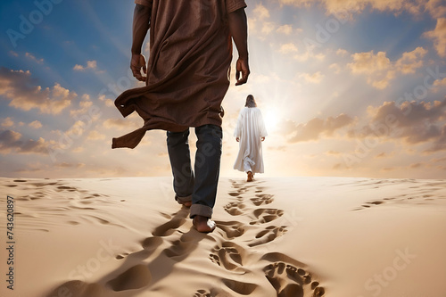 A man walking in the sand following God. Religious theme concept. photo