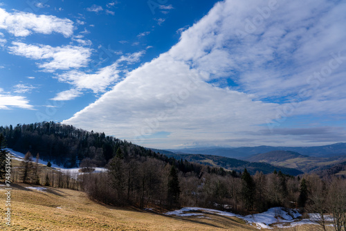 Beskid Sadecki in early spring with High Tatra Mountains at background. View from village Wierchomla, Poland.