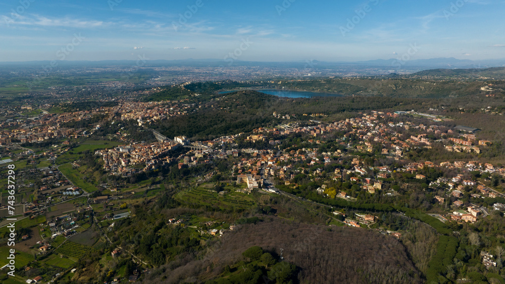 Aerial view of Ariccia, in the Metropolitan City of Rome, Italy. The houses of the town are built on the Alban Hills near the Italian capital. In the background there is Lake Albano.