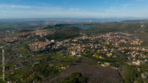 Aerial view of Ariccia, in the Metropolitan City of Rome, Italy. The houses of the town are built on the Alban Hills near the Italian capital. In the background there is Lake Albano.