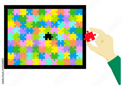 パズルの最後のピースを持つ手