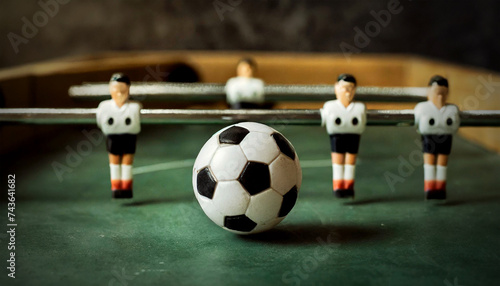 Foosball, closeup of a mini table football game with an old white and black soccer ball, selective focus. Generative Ai. photo