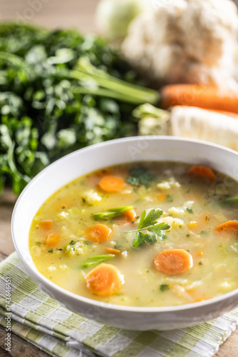 Spring vegetable soup with chopped and grated root vegetables, seasoned with yeast. Healthy vegetable vegetarian food