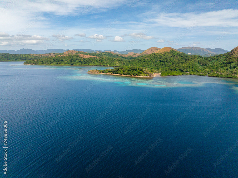 Blue sea around tropical island. Blue sky and clouds. Lajala, Coron. Palawan. Philippines. Blue sea around tropical island. Blue sky and clouds. Lajala, Coron. Palawan. Philippines.
