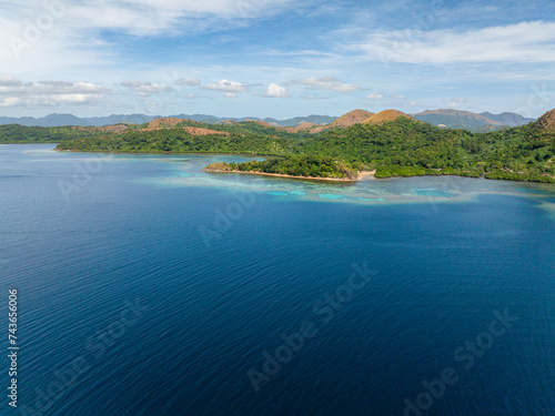 Blue sea around tropical island. Blue sky and clouds. Lajala, Coron. Palawan. Philippines.