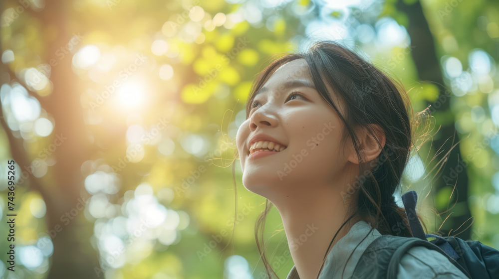 Outdoor, thinking Asian woman with a smile, looking at nature and forest with joy Outdoor, thinking Asian woman with a smile, looking at nature and forest with joy