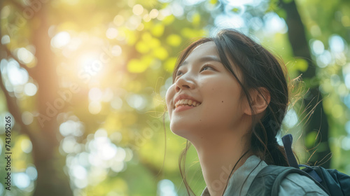 Outdoor, thinking Asian woman with a smile, looking at nature and forest with joy