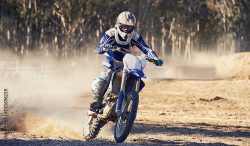 Motorcycle  action and speed with person riding on dirt track  adrenaline and skill for extreme sports outdoor. Competition  adventure and power with risk  fast with biker on motorbike for race