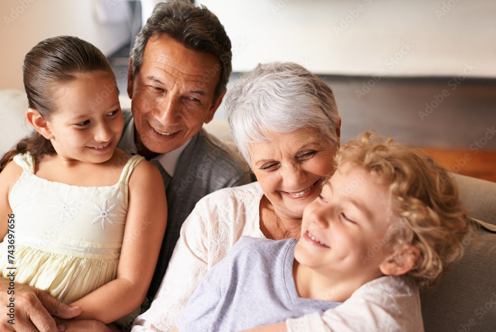 Hug, grandparents and grandchildren with smile for family, photo and multi generation bonding. Senior couple, boy and girl with laugh, love and happiness for playful relationship together at home