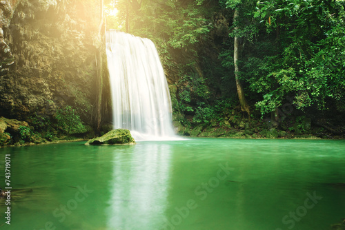 Waterfall in the green forest and golden light at Erawan National Park, Kanchanaburi province, Thailand.