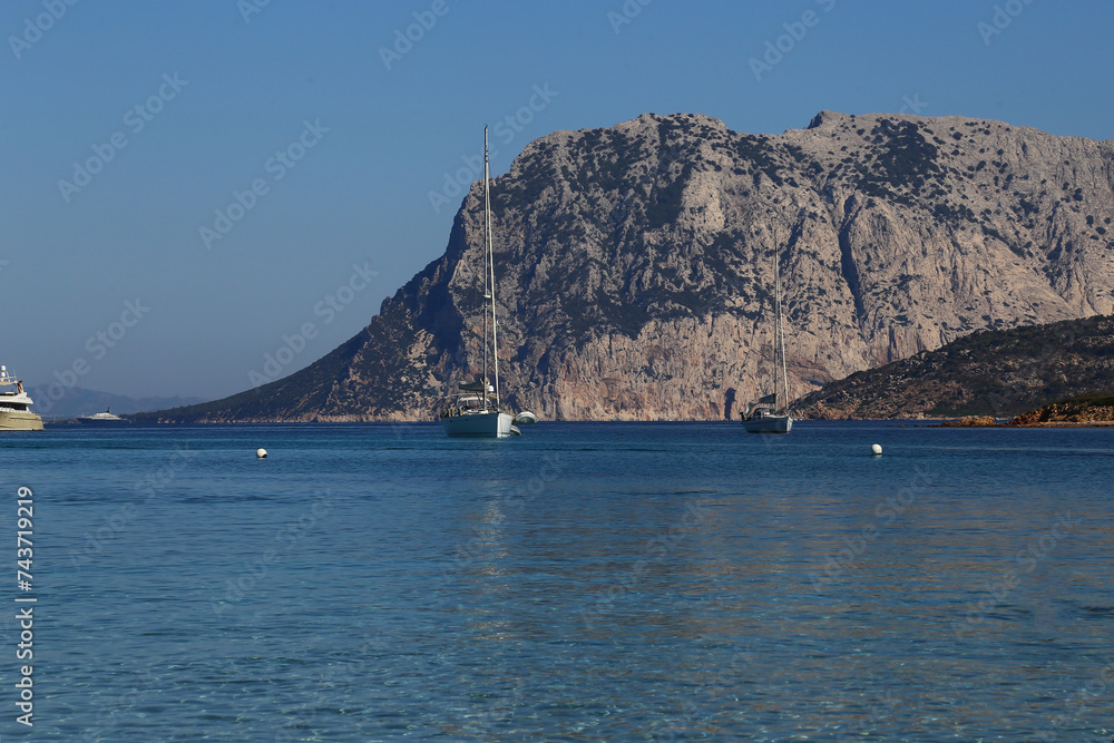 Tavolara Island, yachts and catamarans in Capo Coda Cavallo beach near San Teodoro in Sardinia, Italy