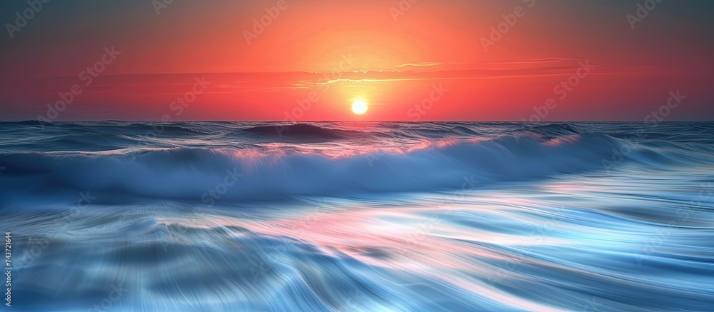 A painting capturing the vivid colors of a sunset as the sun dips below the horizon, casting a warm glow over the ocean waves.