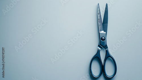 Gray scissors for cutting paper on a white background.