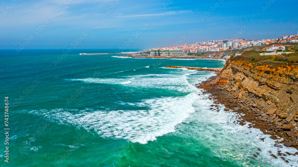 Drone  view over long rocky coastline in Ericeira, Portugal, on summer sunny day.  Top view - Beautiful natural landscape with ocean rocky shore. Aerial view over Scenic European tourist destination.