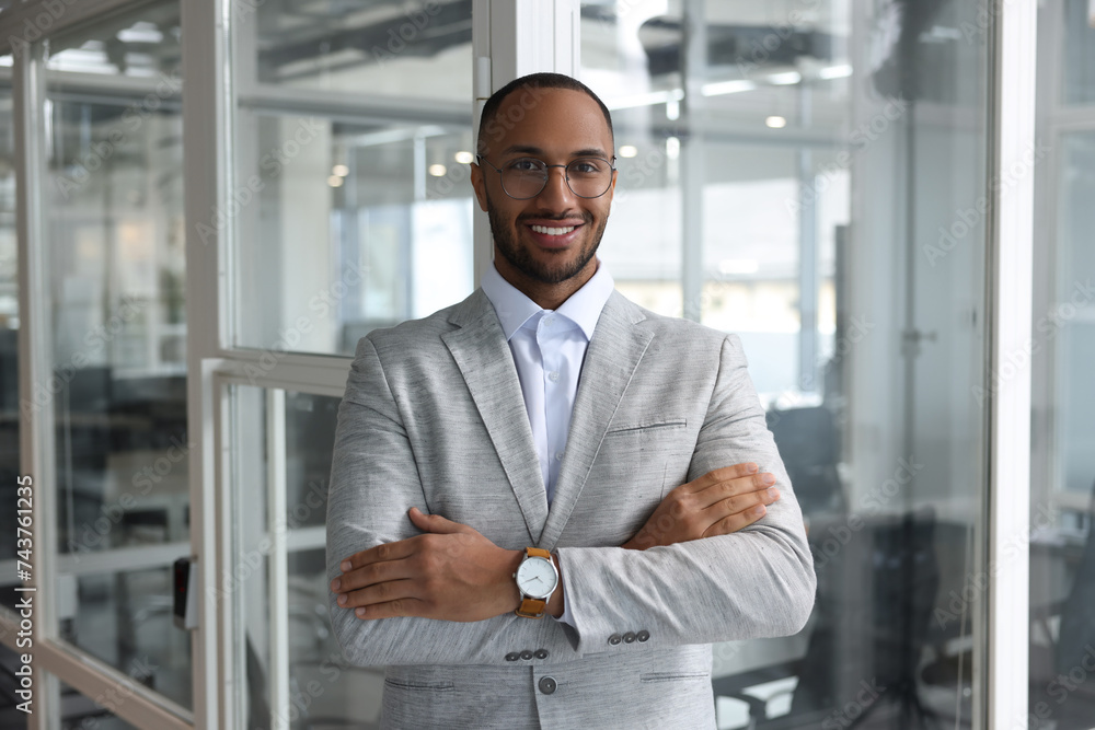 Happy man with crossed arms in office. Lawyer, businessman, accountant or manager Happy man with crossed arms in office. Lawyer, businessman, accountant or manager