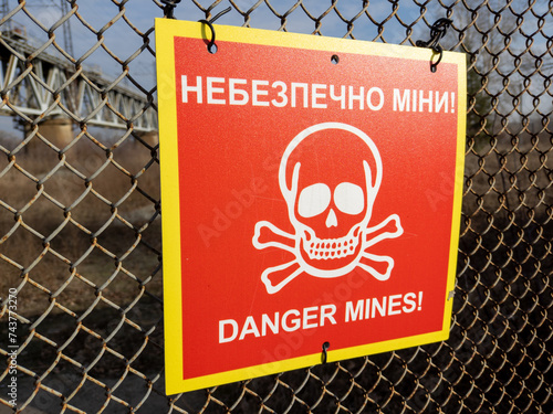 Red sign 'Danger mines' with skull and bones