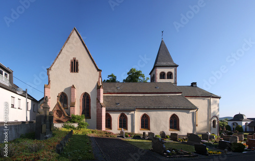 Gothic village church with transept gable and cemetery in Dockweiler, Eifel region in Germany photo