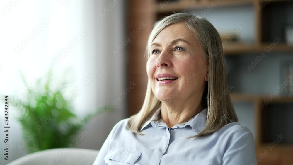 Senior female relaxing with her eyes closed while sitting in the living room. Portrait of a calm happy elderly woman resting breathing deeply on comfortable couch at home. Meditation concept. Close up Senior female relaxing with her eyes closed while sitting in the living room. Portrait of a calm happy elderly woman resting breathing deeply on comfortable couch at home. Meditation concept. Close up