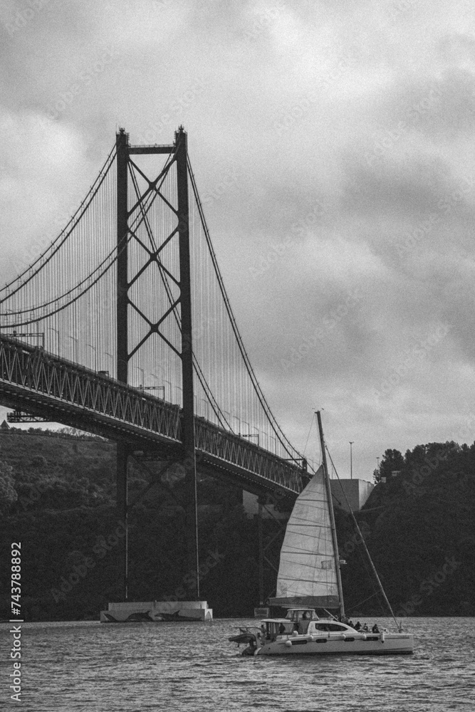 lisbon bridge with boat in vintage black and white