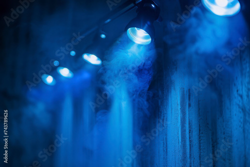 Blue spotlight background with lamps.