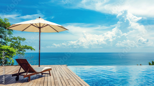 Beautiful landscape of sea ocean on sky with umbrella and chair around luxury outdoor swimming pool in hotel resort for leisure travel and vacation. © NooPaew