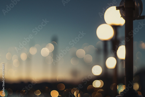 Twilight cityscape bokeh effect with illuminated street lights. Blurred background