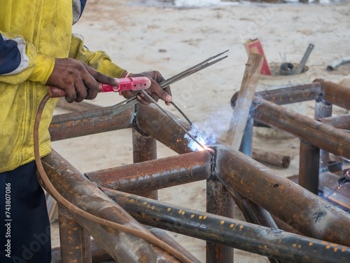 Welding of metal column trusses for building a factory. photo