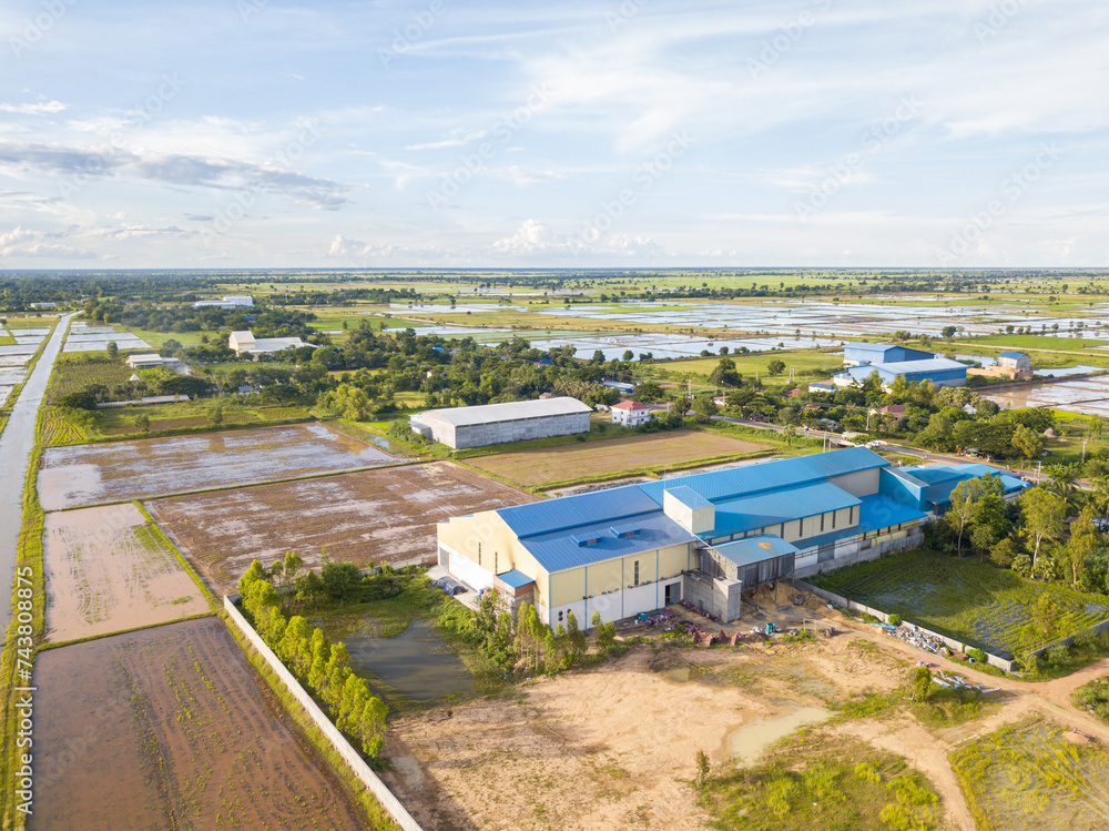 Aerial view of agricultural farmlands with rice mill in the area.