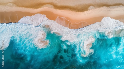 Aerial View of Vibrant Waves Crashing on a Sandy Beach