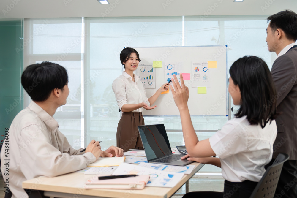 team of Asian businessmen meets to brainstorm ideas about office work management in an office conference room. team of Asian businessmen meets to brainstorm ideas about office work management in an office conference room.