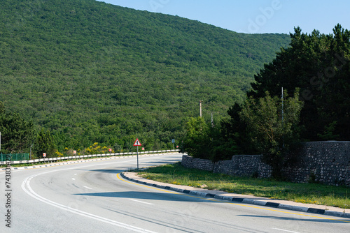 A steep mountain bend of a paved road. Auto travel.