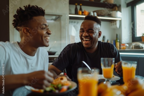 A father and son are having fun having lunch together on Father's Day. A happy young adult and an older man are laughing and chatting at the table. Father's Day concept celebration of men with their