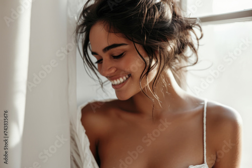 Beautiful young woman in white dress smiling