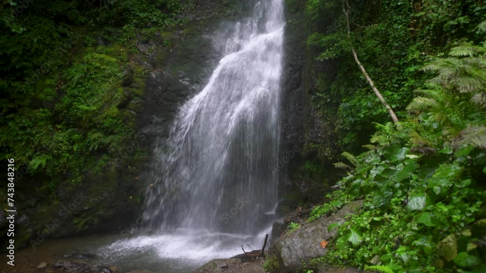 Beautiful waterfall in the forest. Running water and a small lake among the trees. Beautiful nature and relaxation. Beautiful waterfall in the forest. Running water and a small lake among the trees. Beautiful nature and relaxation.