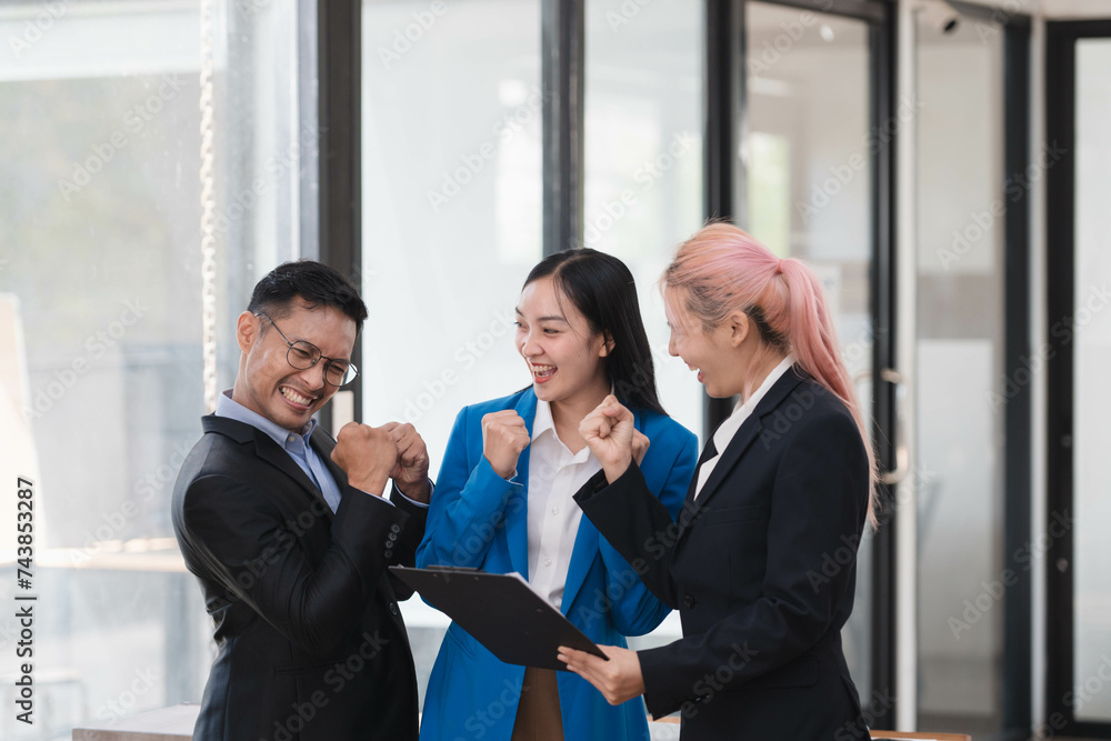 Happy team of Asian business people excited over a good news, achieve new goals. Happy team of Asian business people excited over a good news, achieve new goals.