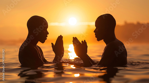 Baptism. Two African American men praying together.