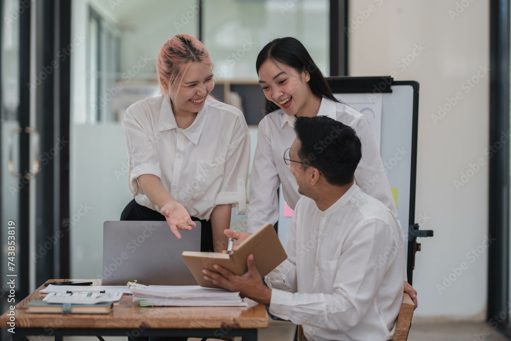 Cheerful young business team working together in the office room. Cheerful young business team working together in the office room.