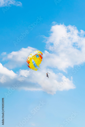 couple rides a parachute on vacation at sea. parasailing against the background of a cloudy sky