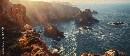 The rugged coastline and hidden coves of the Algarve, Portugal, where cliffs meet the shimmering Atlantic Ocean photo