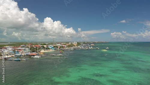 Aerial drone view of San Pedro, Ambegris Caye in Belize. Flying over tropical Caribbean island. Boats and docks.