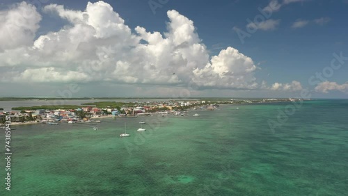 Aerial drone view of San Pedro, Ambegris Caye in Belize. Airplane flying over tropical Caribbean island. Boats and docks.