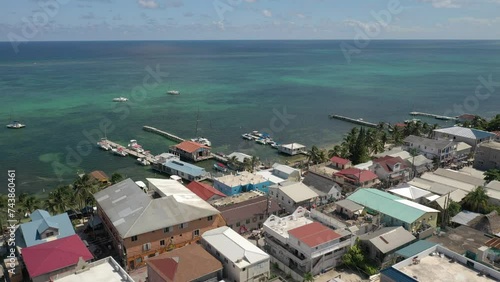 Aerial drone view of San Pedro, Ambegris Caye in Belize. Flying over tropical Caribbean island. Boats and docks.