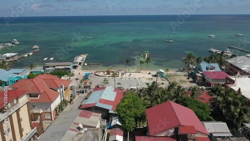 Aerial drone view of San Pedro, Ambegris Caye in Belize. Flying over tropical Caribbean island. Boats and docks.
