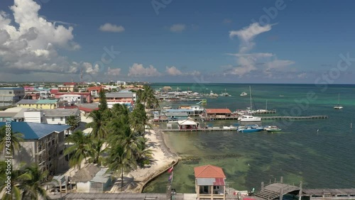 Aerial drone view of San Pedro, Ambegris Caye in Belize. Flying over tropical Caribbean island. Boats and docks.