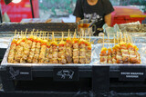 Assorted Grilled Skewers at a Street Food Stand