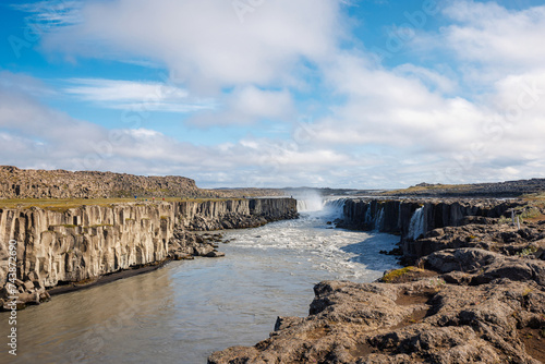 Majestic rainbow over Dettifoss waterfall in Iceland, the second most powerful waterfall in Europe, on a spring day photo