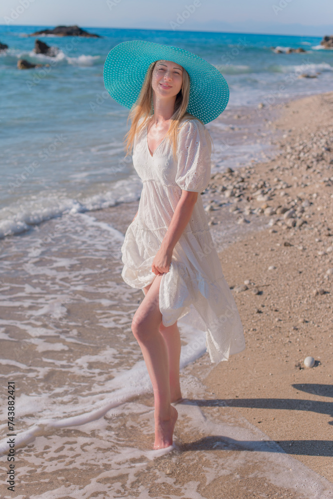 Girl in a blue hat on the sea beach. Girl in a blue hat on the sea beach.