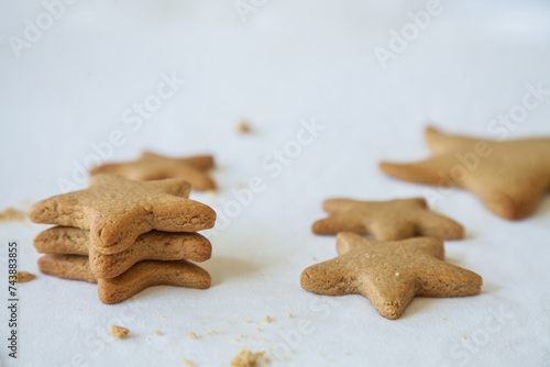 Baked gingerbread christmas star biscuits on white photo