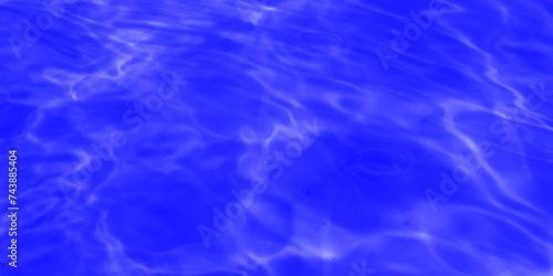 Modern Vivid deep blue water background. Transparent water in pool. Blue water with ripples on the surface. Defocus blurred blue water shining in the sea. rippled water detail background. 